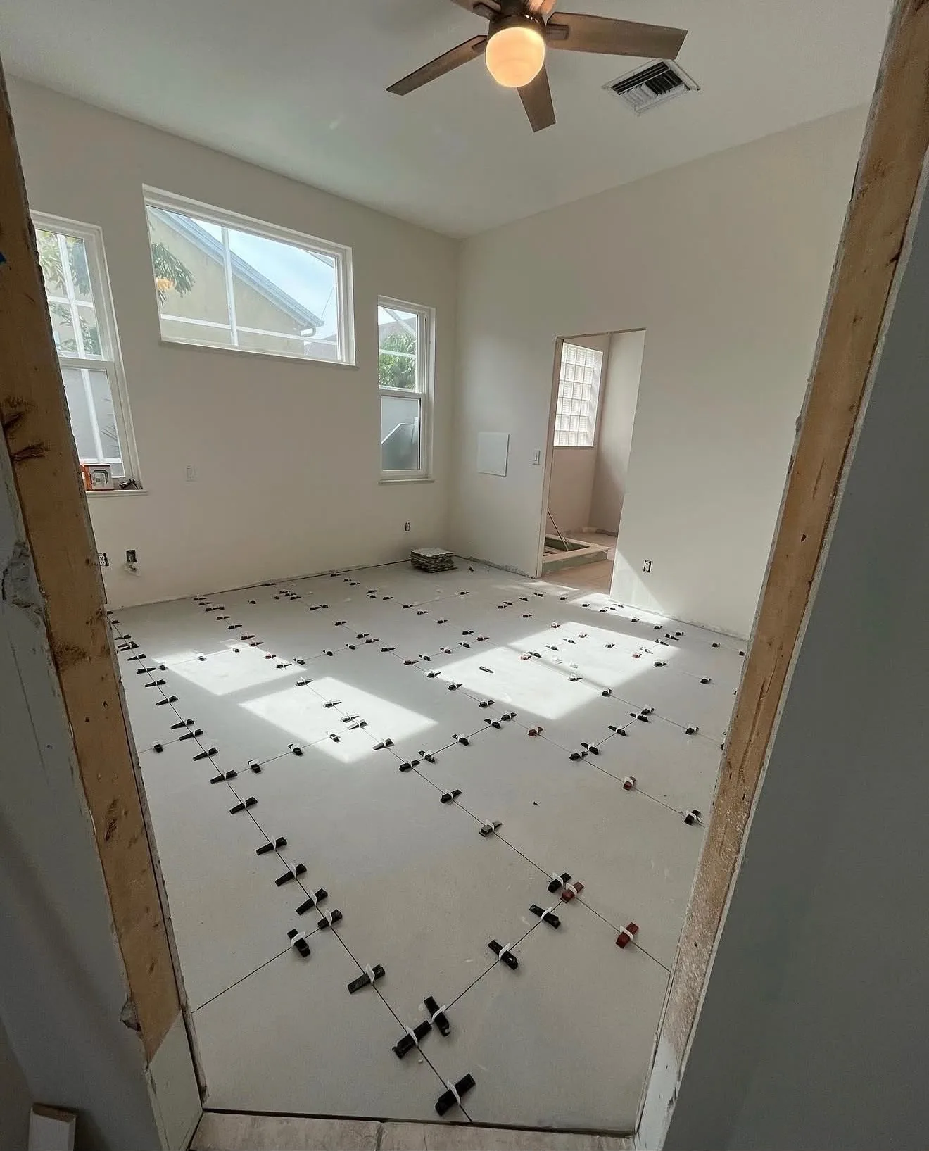 Large-format tile being set in a primary bedroom