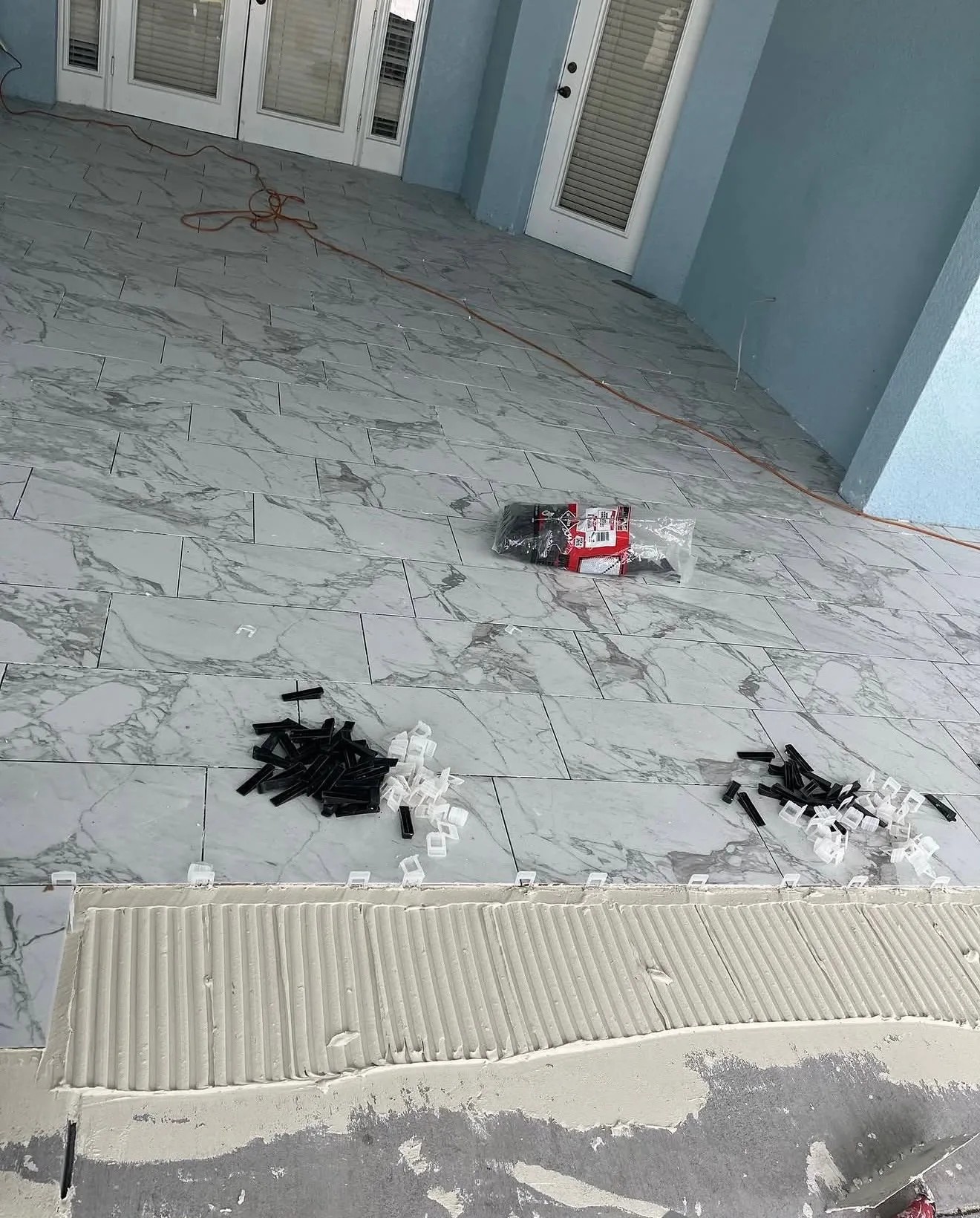 Thinset troweled and tile spacers laid out before setting the lanai floor tile