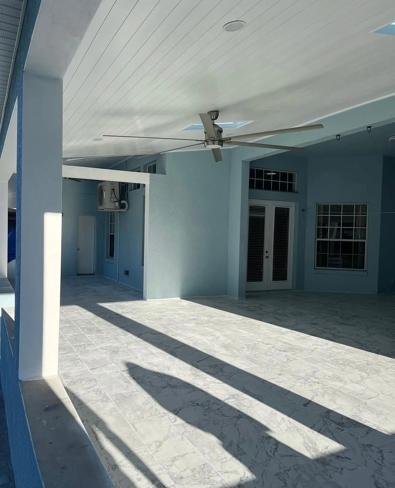 Wide view of finished lanai flooring in large-format porcelain tile