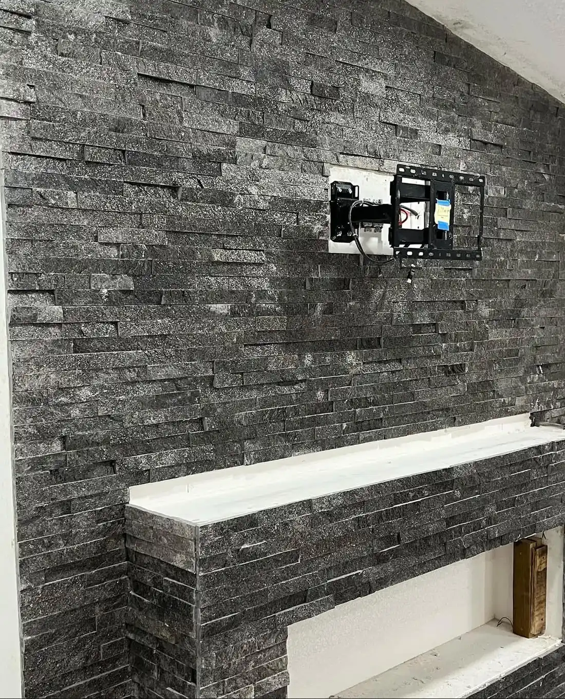 Stacked stone fireplace wall in progress